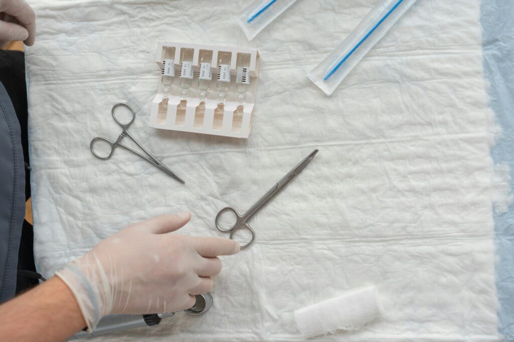 Aerial view of medical tools and supplies arranged on a sterile sheet in a healthcare setting.
